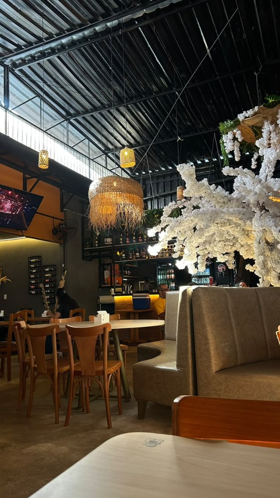 Ambiente do restaurante Costa Grill com mesas, cabines e bar